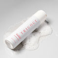 Load image into Gallery viewer, Close-up texture of Tricoci Volumizing Shampoo showing rich lathering formula